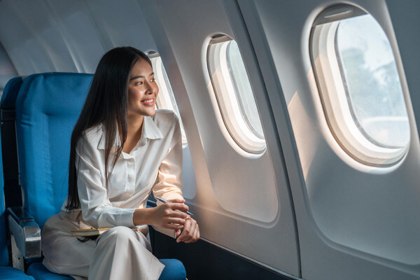 asian-woman-sitting-in-a-seat-in-airplane-and-looking