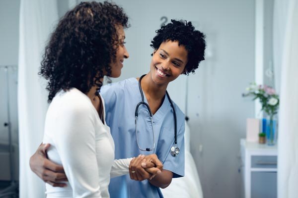 front-view-of-happy-african-american-female-doctor-helping-female