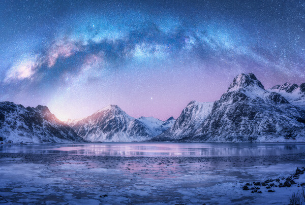 milky-way-above-frozen-sea-coast-and-snow-covered-mountains