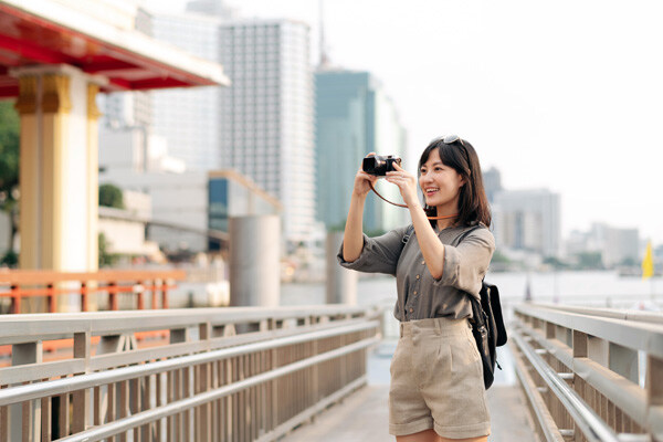 young-asian-woman-backpack-traveler-using-a-camera-in-express