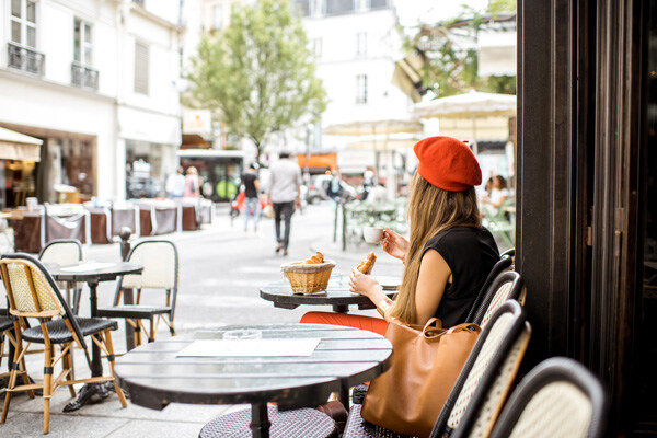 young-stylish-woman-in-red-beret-having-a-french-breakfast