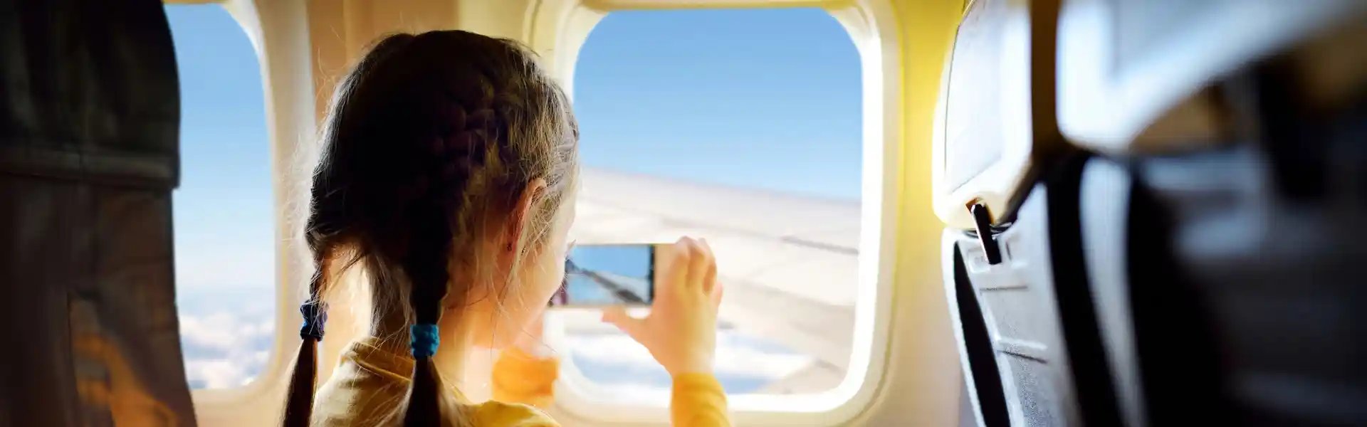 adorable-little-girl-traveling-by-an-airplane