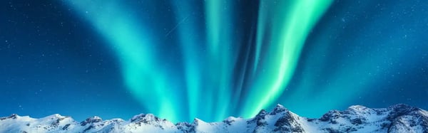 aurora-borealis-above-the-snow-covered-mountains-in-lofoten-islands-