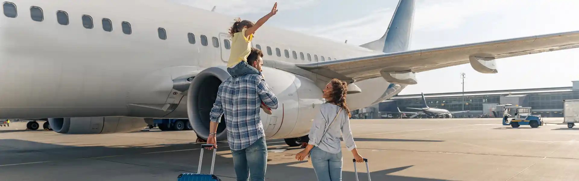 back-view-of-happy-family-standing-near-a-large-plane