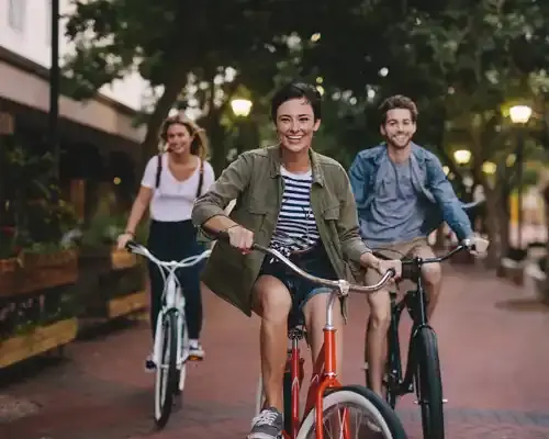 three-young-people-cycling-down-the-street