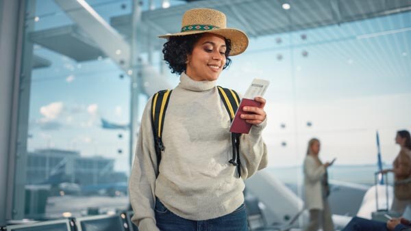 airport-terminal--happy-traveling-black-woman-looks-around-searching-flight