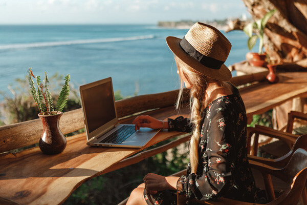 business-woman-working-with-computer-on-the-beach.-freelance-concept