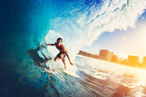 surfer-on-blue-ocean-wave-getting-barreled-at-sunrise