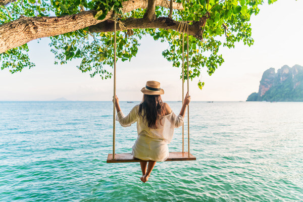 traveler-woman-relaxing-on-swing-above-andaman-sea-railay-beach