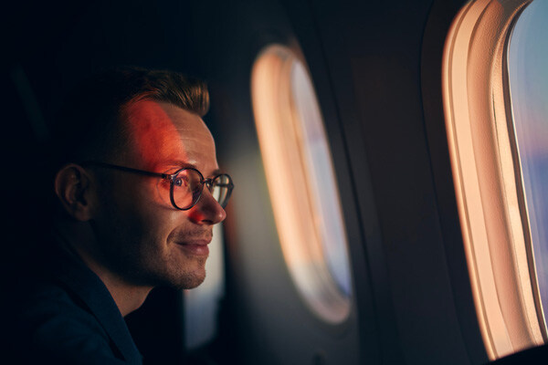 young-man-with-eyeglasses-traveling-by-airplane