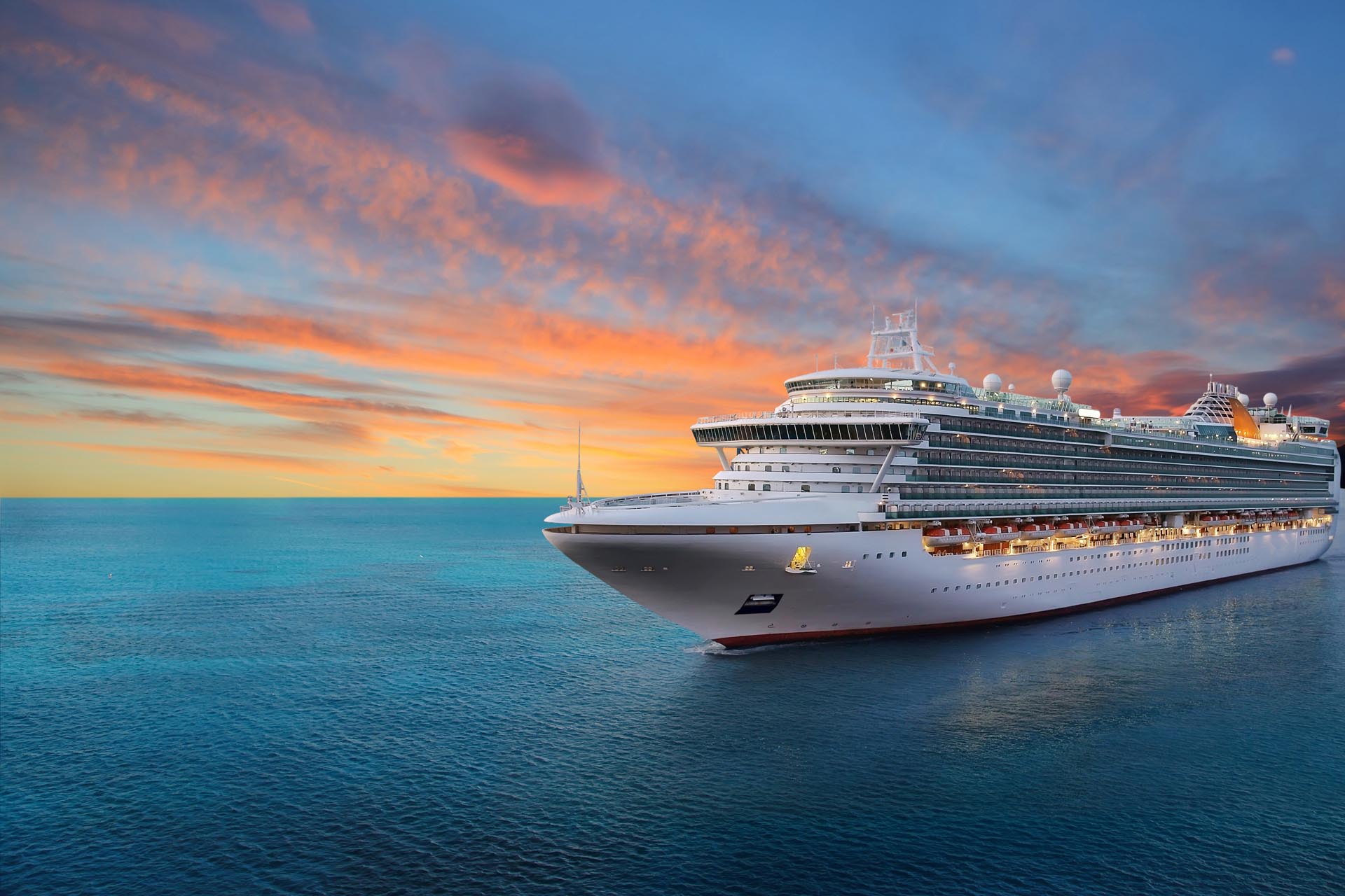 luxury-cruise-ship-sailing-to-port-on-sunrise-1