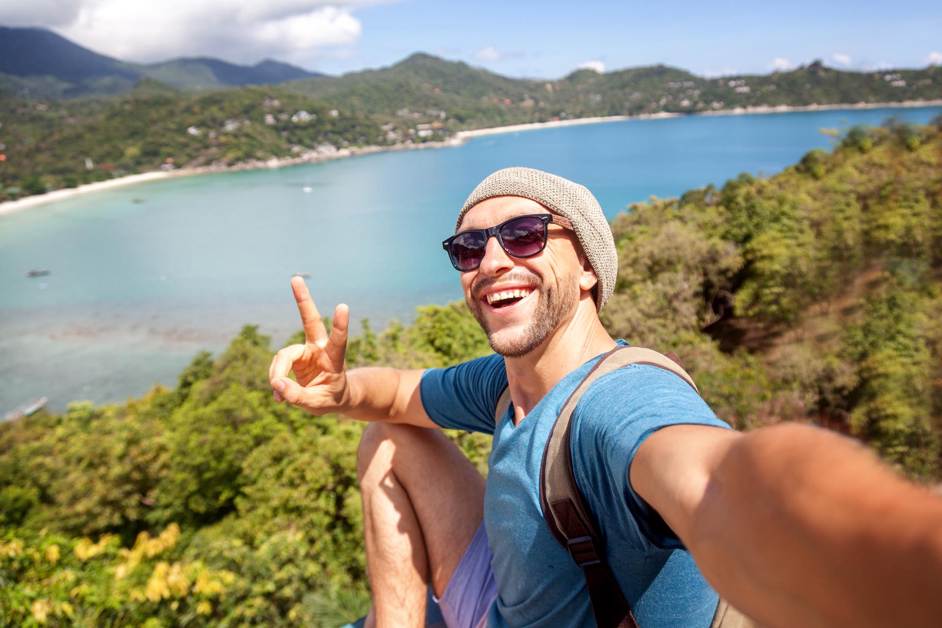 young-male-hipster-traveler-doing-selfie-overlooking-the-tropical-sea-1