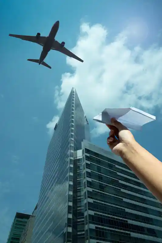 a-womans-hand-play-with-a-paper-airplane-in-front