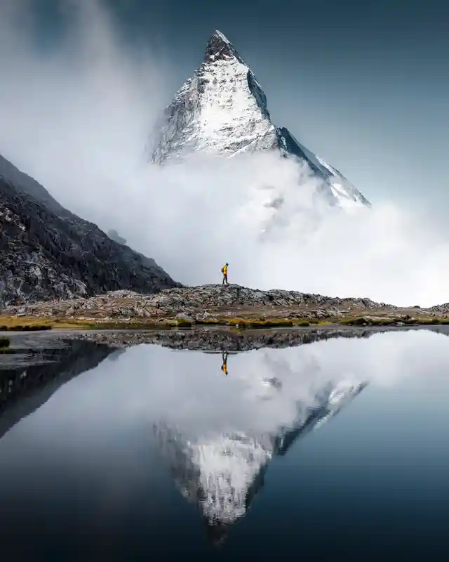 hiker-man-walks-alone-through-the-incredible-swiss-alps-with